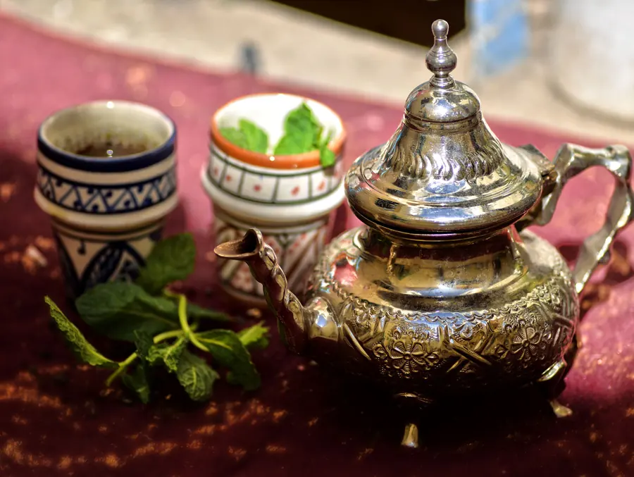 A silver teapot and two glasses of mint tea